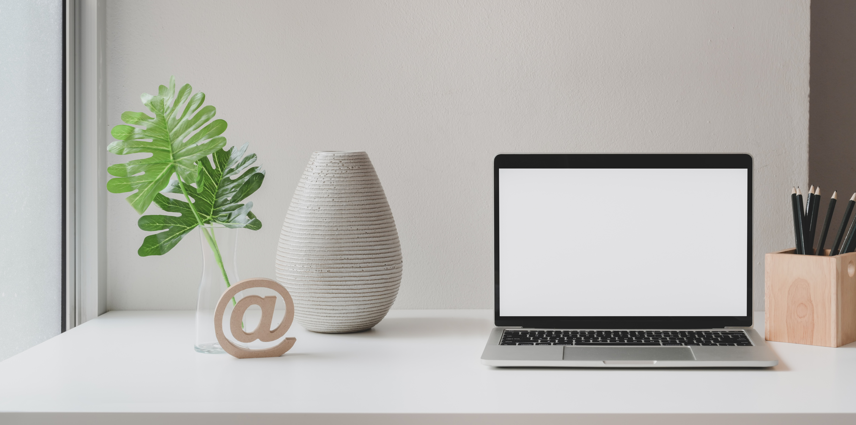 Laptop placed on white table in creative workplace